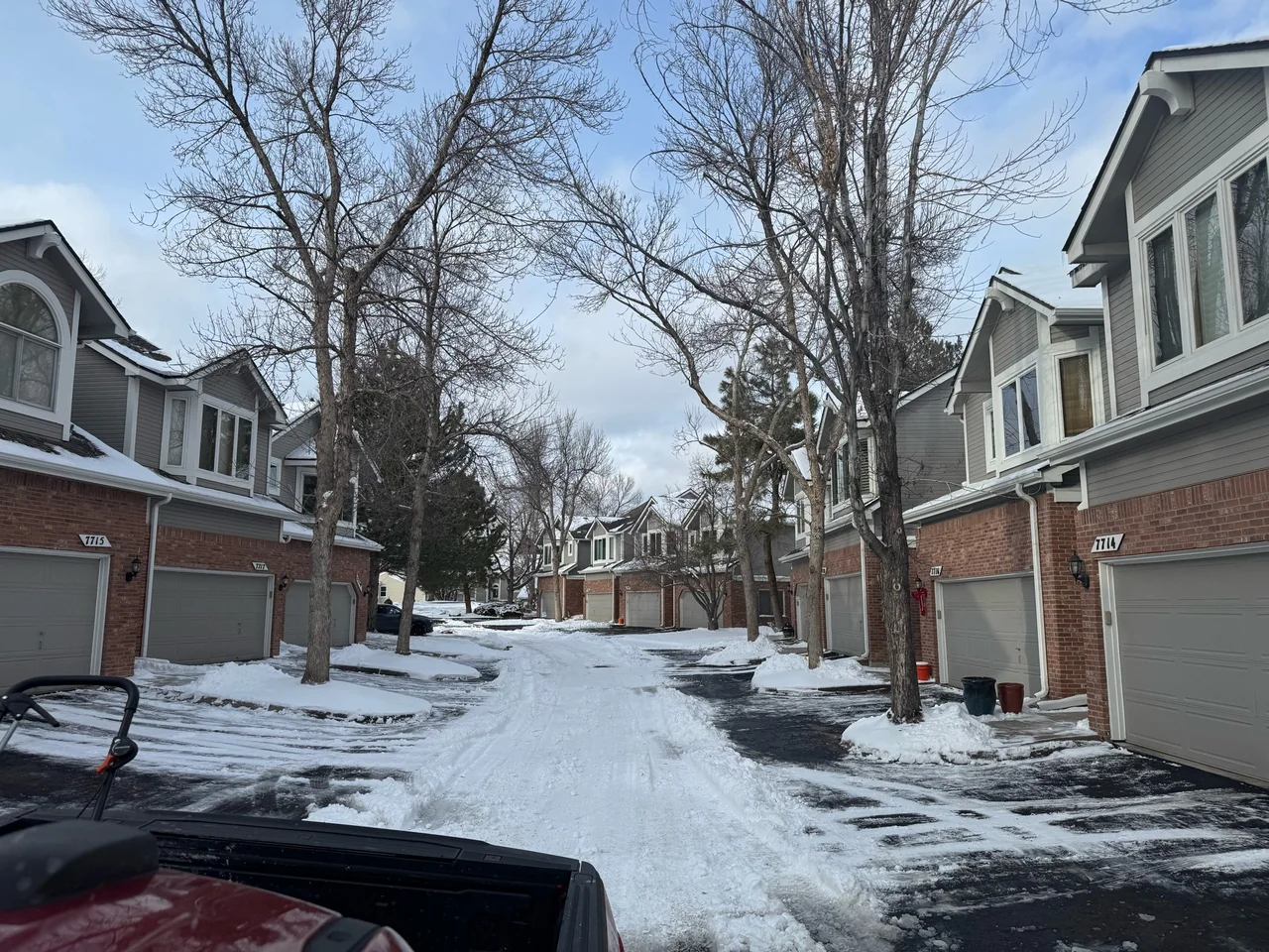 Townhome driveways and a shared lane with snow remaining
