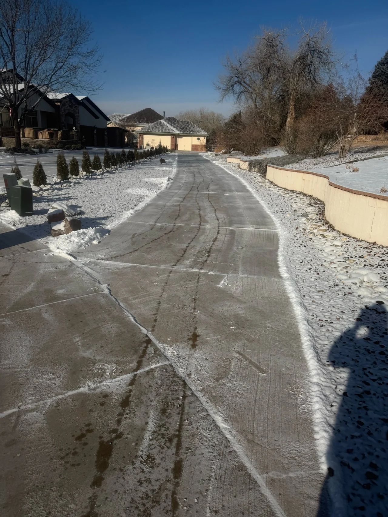 Long driveway with snow along its edges